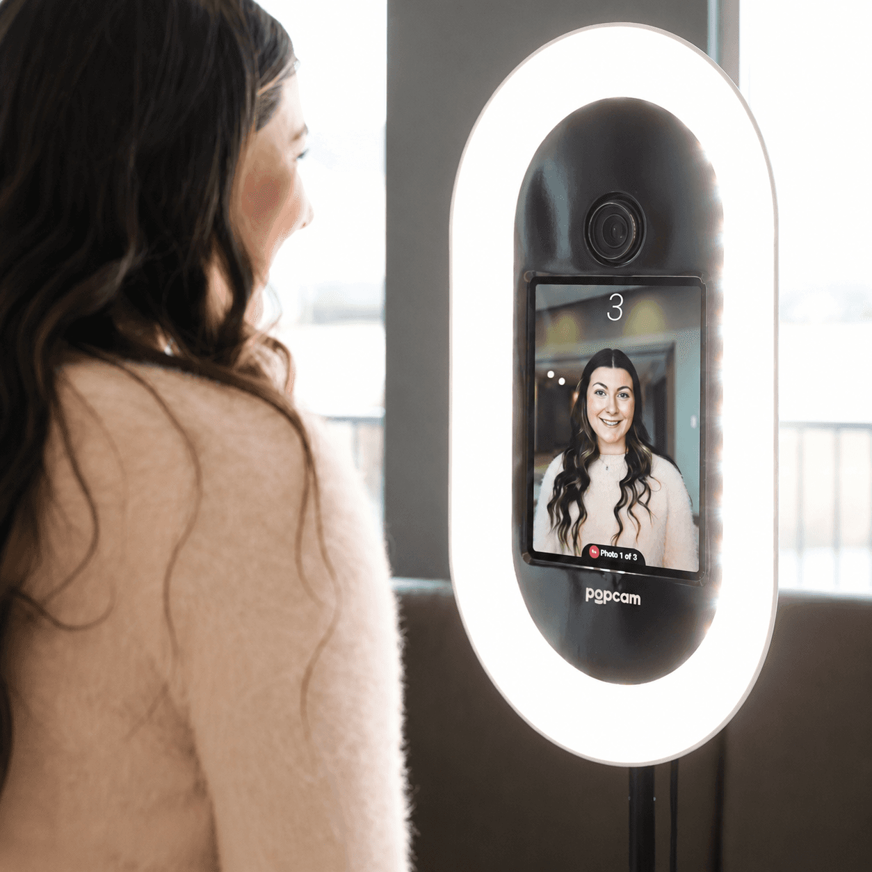 A member taking a headshot at a Popcam kiosk